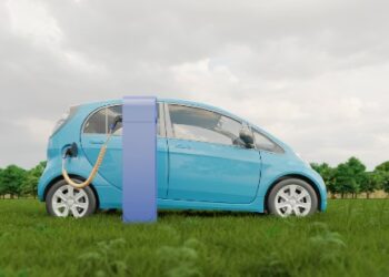 Coche azul electrico cargando en el campo